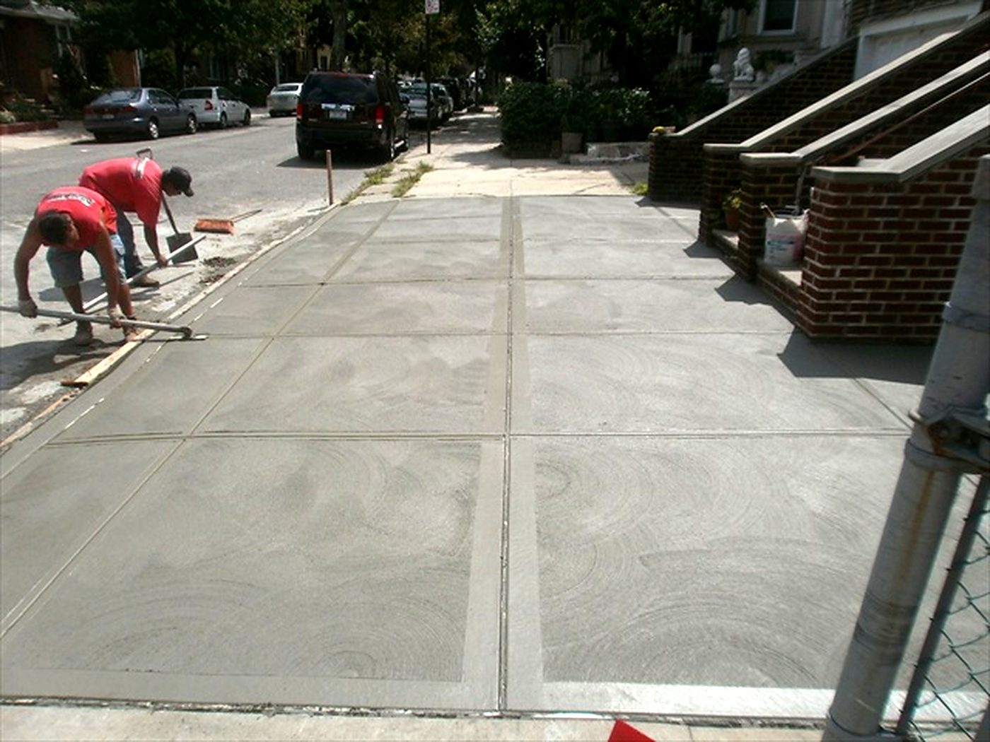 A concrete path finished along a front garden